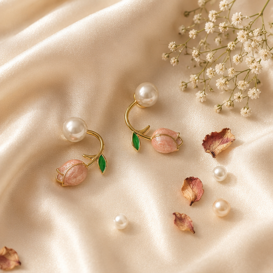 Close-up of pink tulip and pearl stud earrings with green enamel leaf on gold-tone vine – floral everyday earrings for Indian women