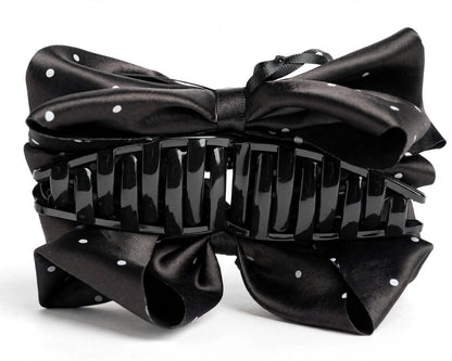 Side angle view of black satin polka dot bow hair claw clip