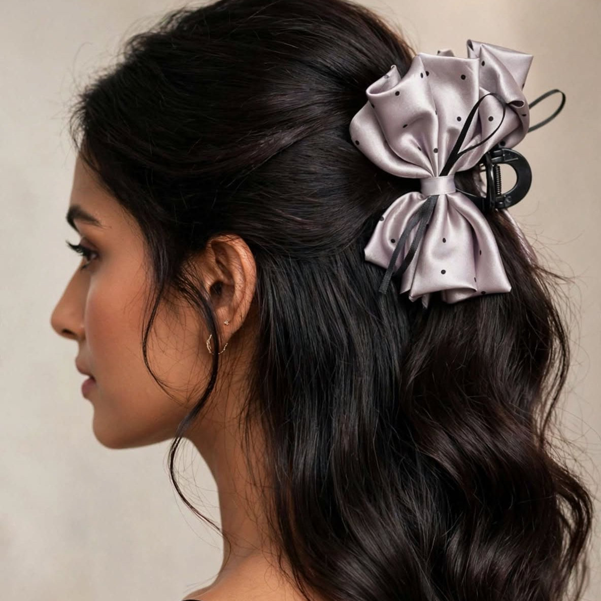 Studio shot of silver satin polka dot bow hair clutcher