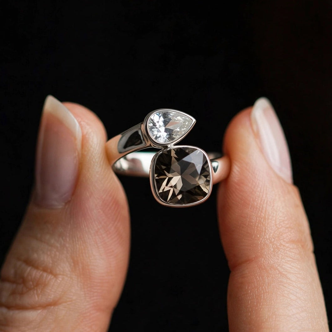 Close-up of clear pear-cut and smoky brown cushion-cut crystals on silver ring for women at JeevaFashions