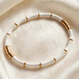 Close-up of white enamel bamboo segments with gold accents for women at JeevaFashions