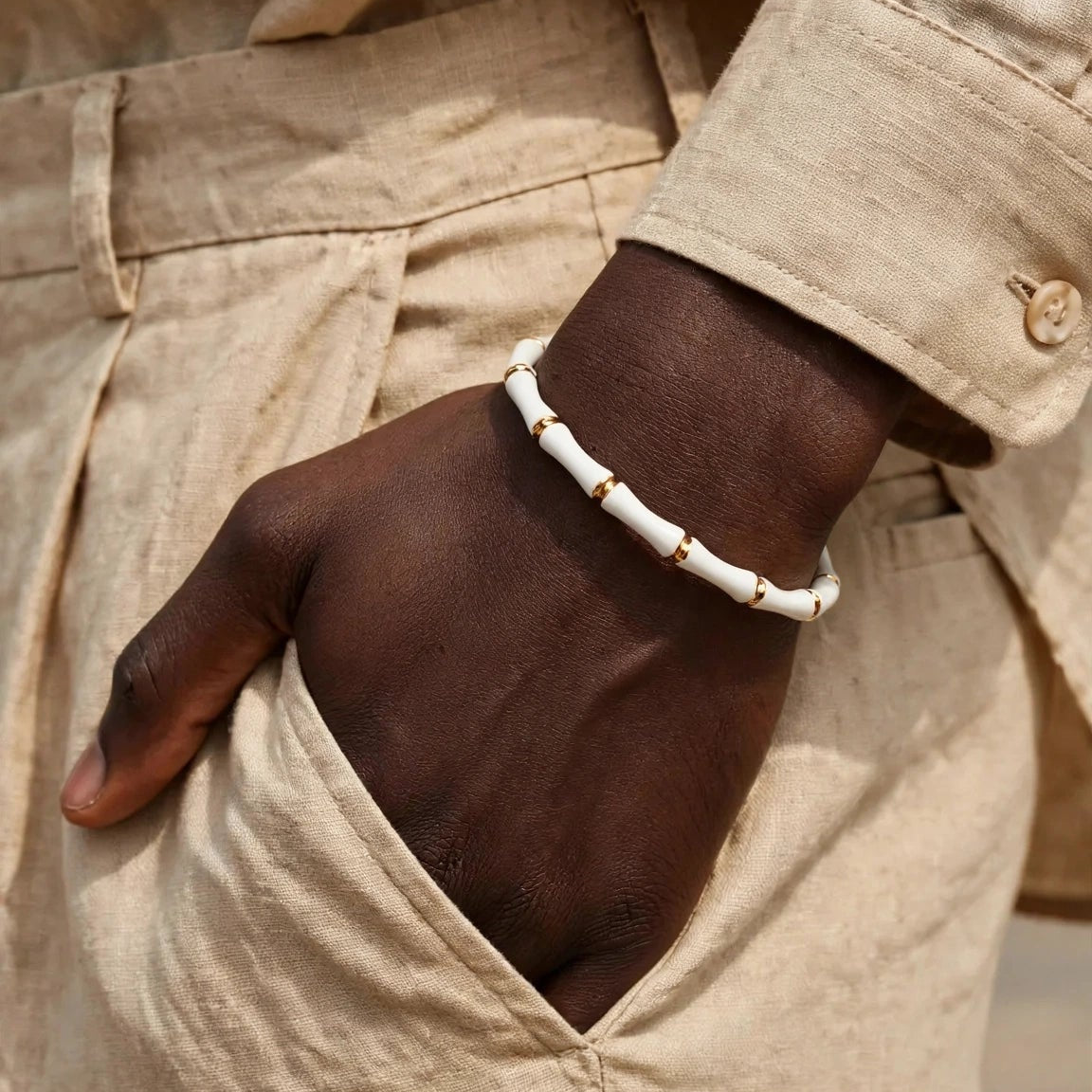 Side angle of white enamel bamboo bracelet with gold hardware for women at JeevaFashions