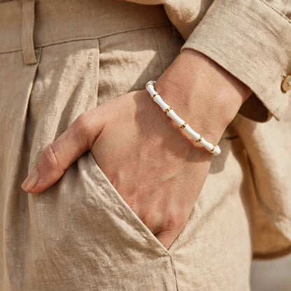 White enamel bamboo bracelet styled on wrist for women at JeevaFashions