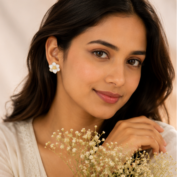 Gold plated white enamel flower earrings closeup for women JeevaFashions