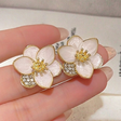 White flower stud earrings with gold tone CZ accent for women JeevaFashions