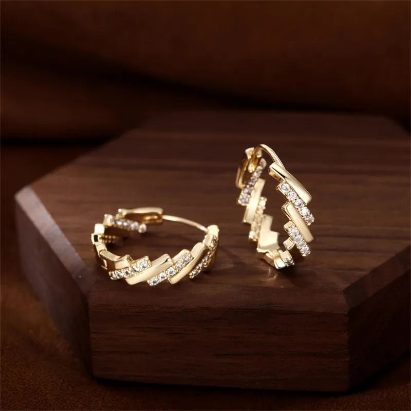 Geometric gold zigzag hoop earrings closeup